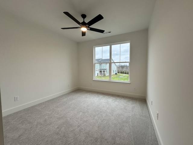 unfurnished room featuring ceiling fan and light carpet