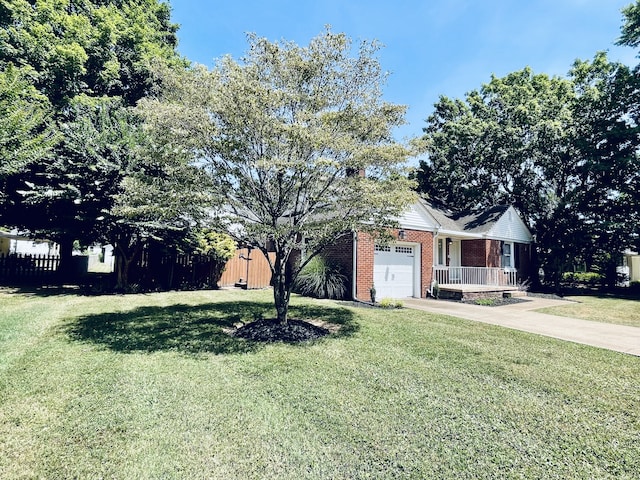 ranch-style house with a garage, a front lawn, and covered porch