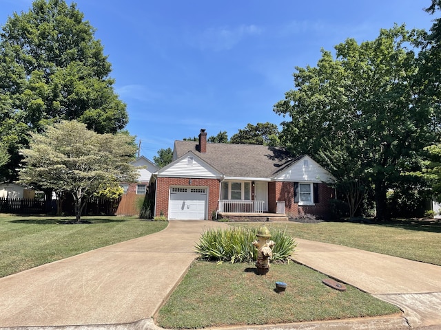 ranch-style home featuring a garage, a front yard, and covered porch