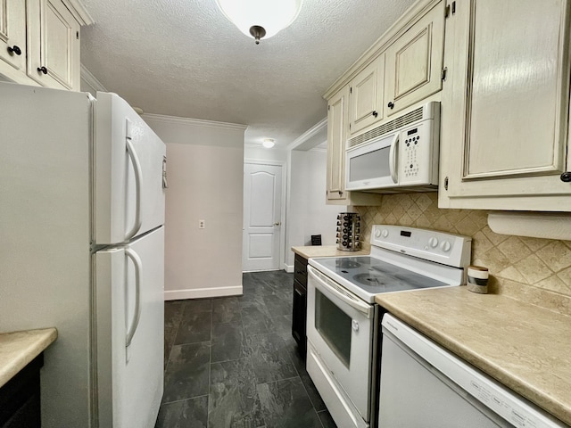 kitchen with cream cabinets, dark tile patterned flooring, decorative backsplash, crown molding, and white appliances