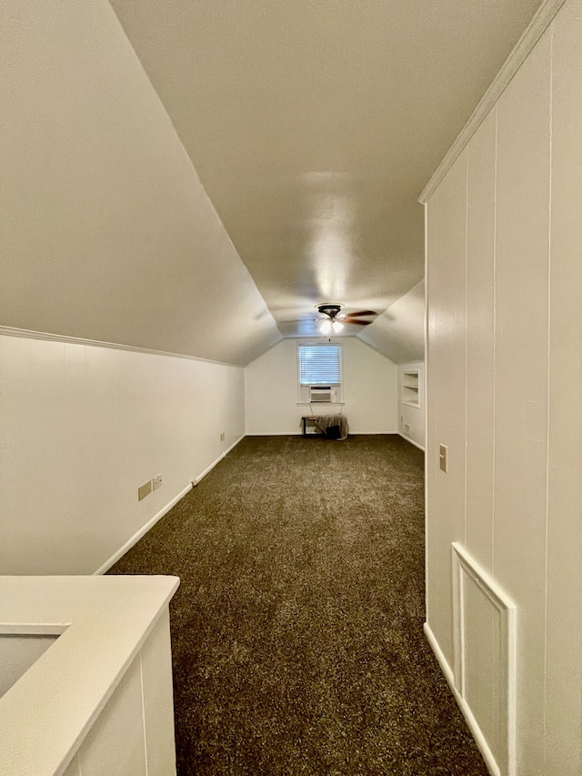 bonus room featuring dark colored carpet and vaulted ceiling