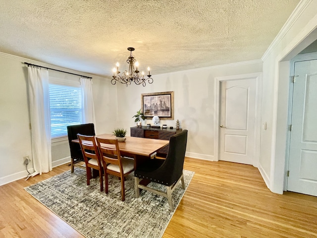 dining room with a chandelier, a textured ceiling, hardwood / wood-style flooring, and crown molding