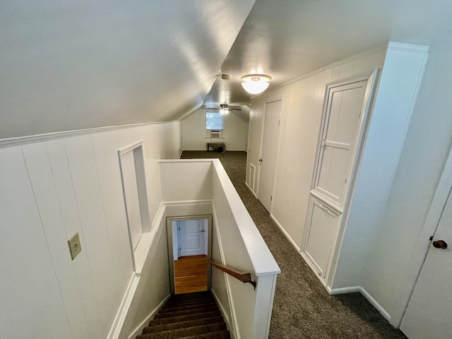 staircase featuring vaulted ceiling, carpet flooring, and ceiling fan