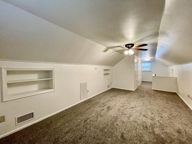 bonus room featuring built in features, vaulted ceiling, carpet flooring, and ceiling fan