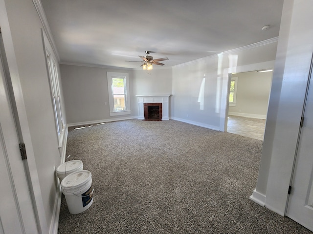 unfurnished living room featuring carpet floors, crown molding, a fireplace, and ceiling fan