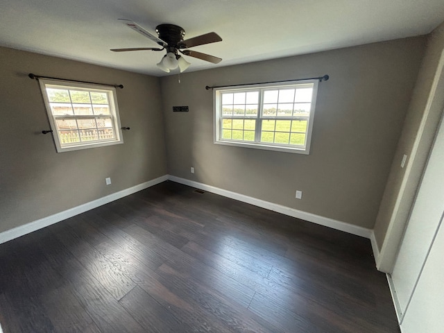 unfurnished room featuring ceiling fan, dark hardwood / wood-style flooring, and a healthy amount of sunlight