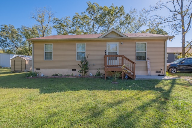 view of front facade with a storage shed and a front yard