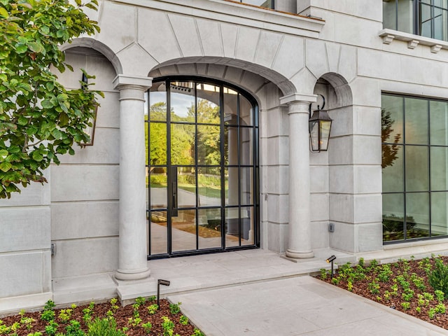 view of exterior entry featuring french doors