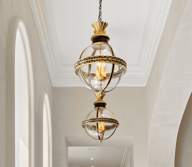 interior details featuring ornamental molding and a chandelier