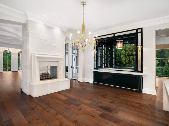 unfurnished dining area featuring an inviting chandelier, dark hardwood / wood-style floors, and ornamental molding