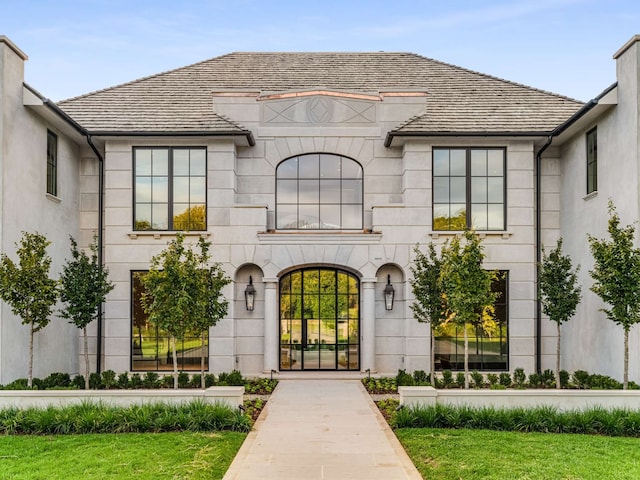 entrance to property featuring a lawn