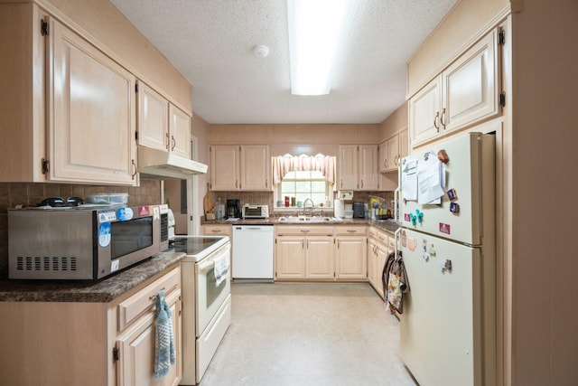 kitchen with a sink, white appliances, tasteful backsplash, light floors, and under cabinet range hood