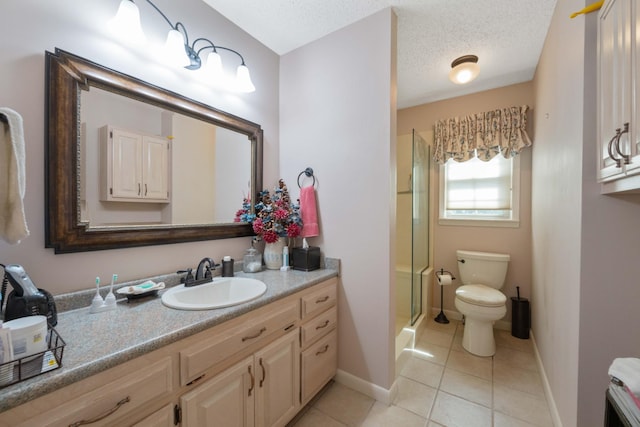full bathroom featuring toilet, a shower with shower door, tile patterned floors, baseboards, and vanity