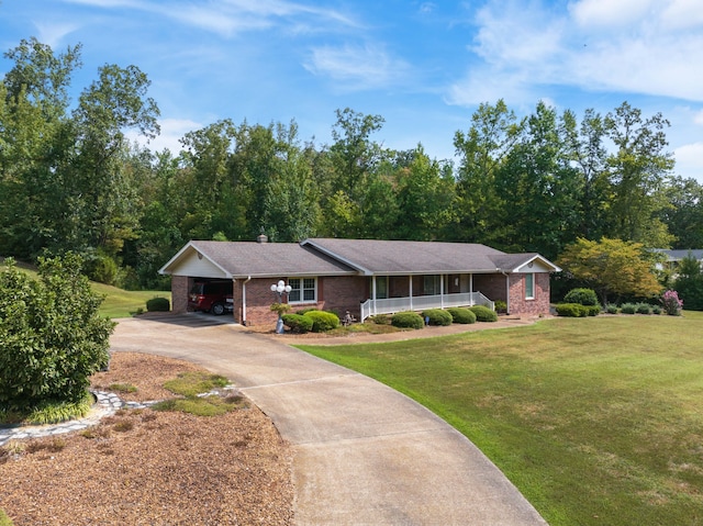 ranch-style house with a carport, covered porch, and a front yard