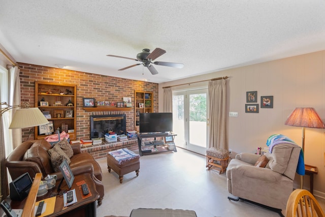 living room featuring a brick fireplace, a textured ceiling, brick wall, and ceiling fan