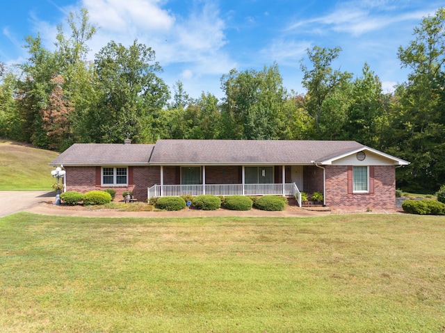 ranch-style home featuring a porch and a front lawn