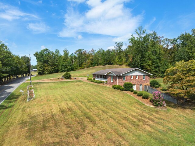 split foyer home with a garage, brick siding, and a front yard