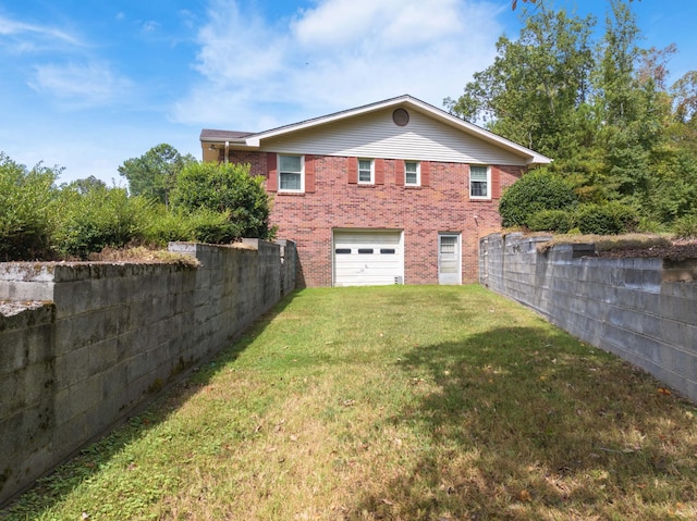 rear view of house with driveway, an attached garage, brick siding, and a lawn