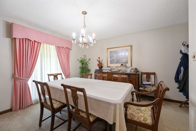 dining space with an inviting chandelier, a textured ceiling, and light carpet