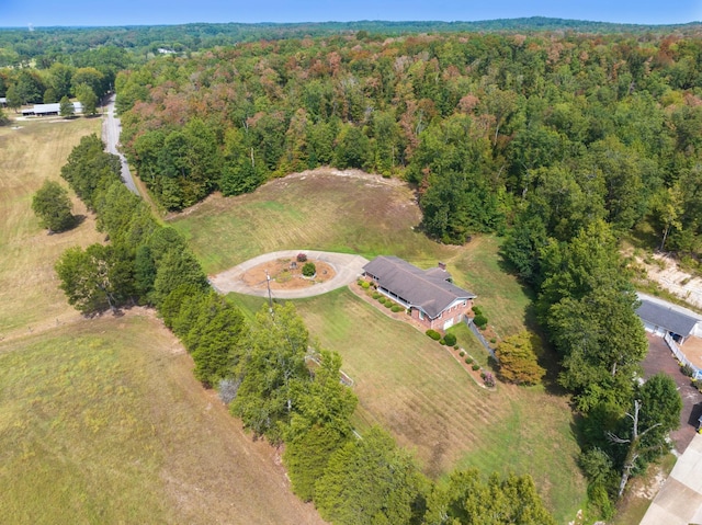 birds eye view of property with a view of trees