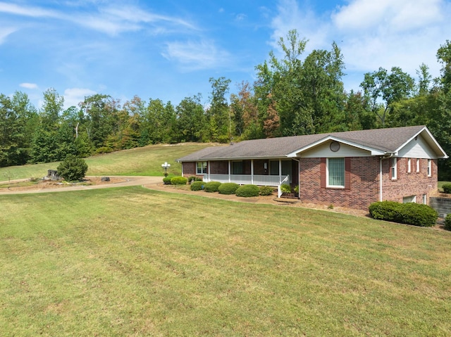 view of front facade with a front lawn and brick siding