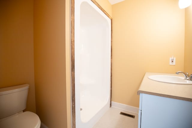 bathroom featuring tile patterned floors, vanity, and toilet