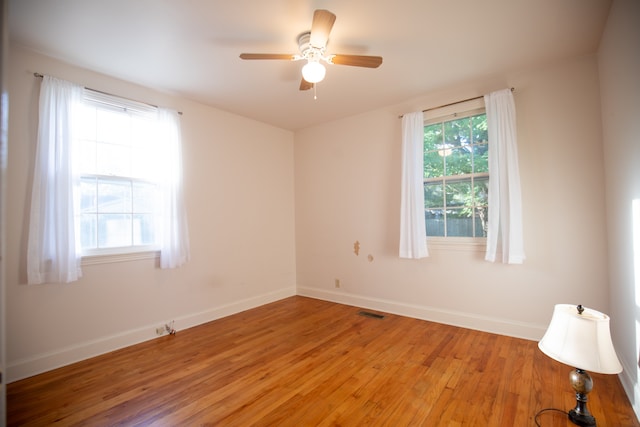 empty room featuring ceiling fan and light wood-type flooring