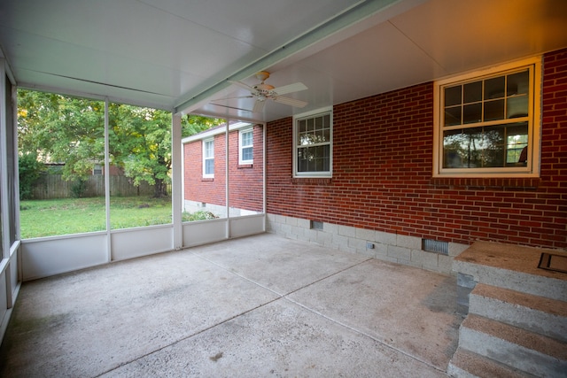 unfurnished sunroom with ceiling fan