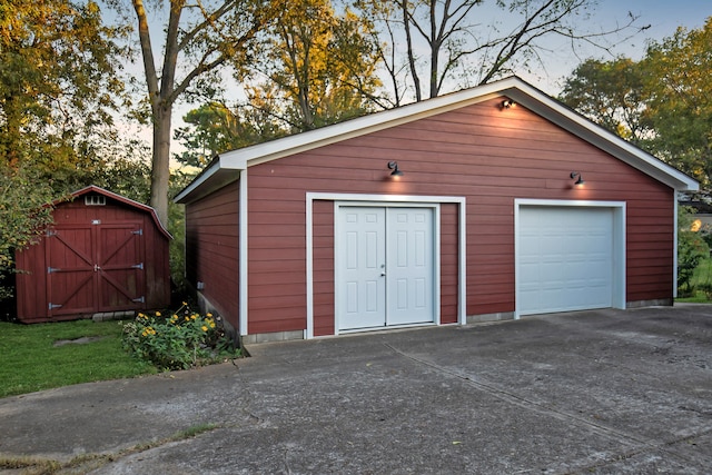 view of garage at dusk