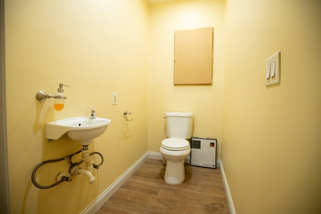 bathroom with wood-type flooring and toilet