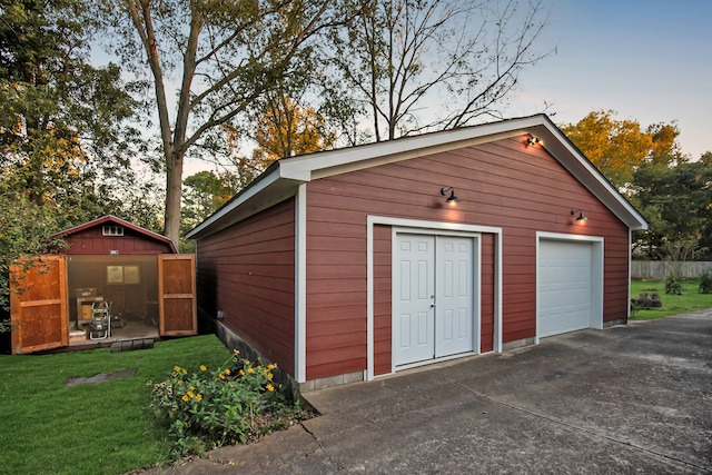 outdoor structure at dusk with a yard and a garage