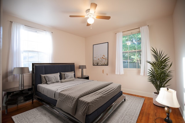 bedroom featuring ceiling fan and dark hardwood / wood-style flooring