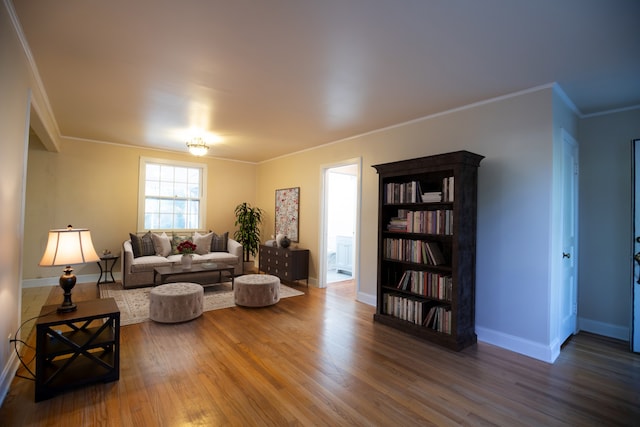 living room featuring crown molding and hardwood / wood-style flooring