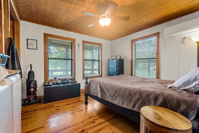 bedroom with ceiling fan, wood walls, hardwood / wood-style floors, and wooden ceiling