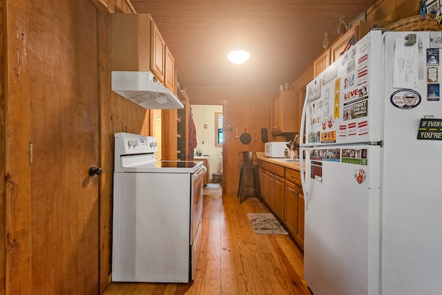 kitchen featuring light wood-type flooring and white appliances