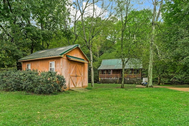 view of outbuilding featuring a yard