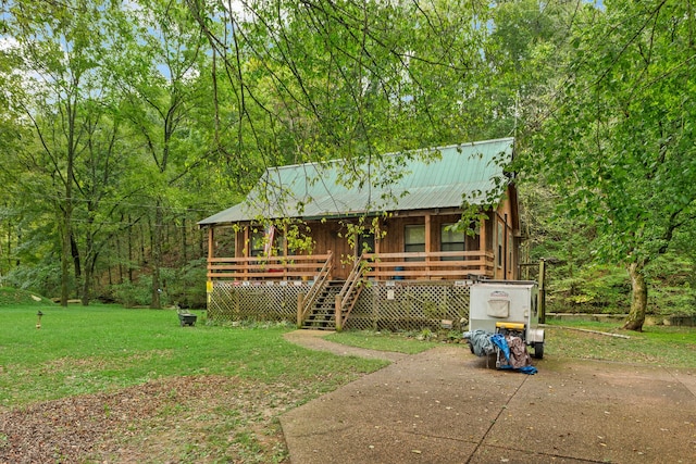 view of outbuilding with a yard and covered porch