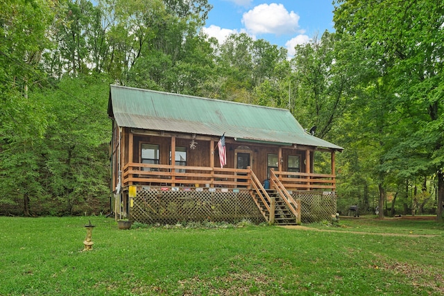 log cabin with a front lawn