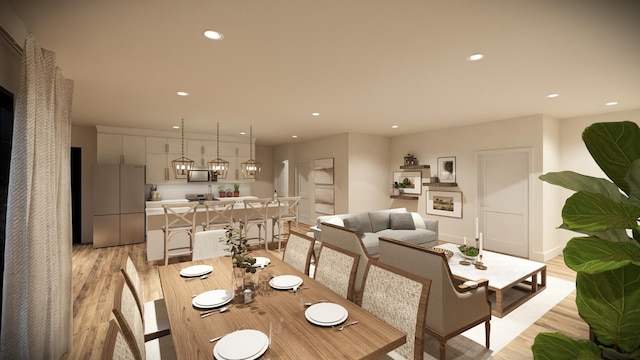 dining space with light hardwood / wood-style flooring and a chandelier