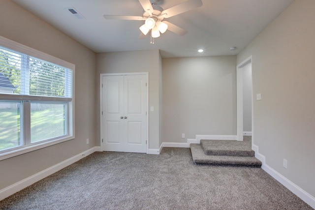 interior space featuring ceiling fan, a closet, and carpet