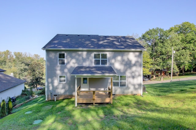 back of property featuring a wooden deck and a yard