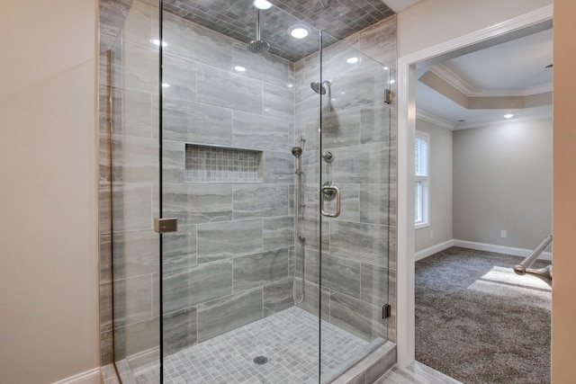 bathroom featuring ornamental molding and a shower with shower door