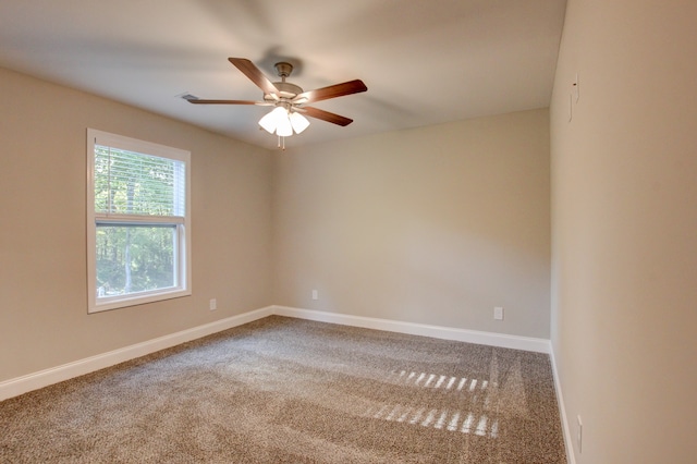 carpeted spare room with ceiling fan