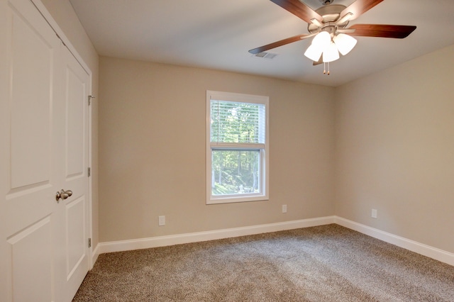 empty room with carpet flooring and ceiling fan