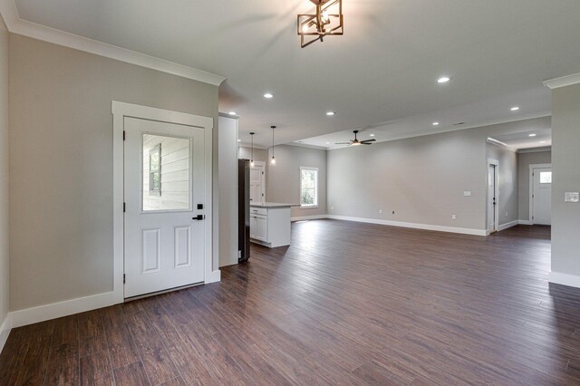 unfurnished living room featuring crown molding, a ceiling fan, baseboards, recessed lighting, and dark wood-style floors