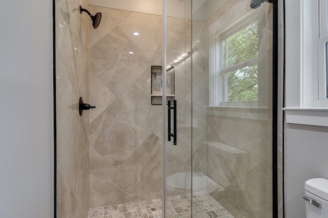 full bathroom with a stall shower and toilet