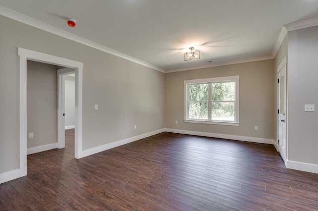 unfurnished room featuring crown molding, dark wood finished floors, and baseboards