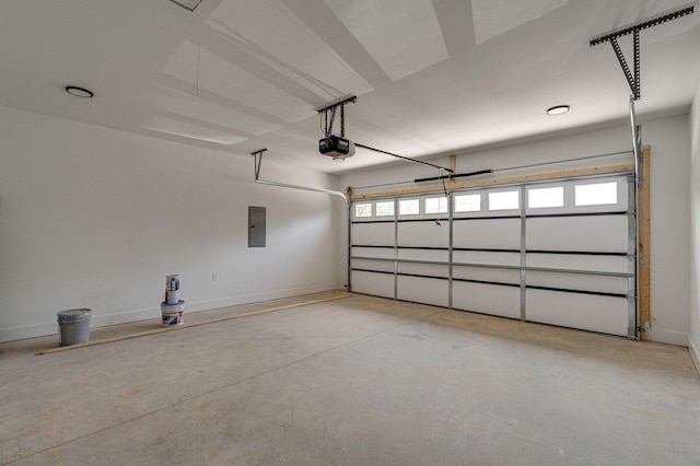 garage featuring baseboards, a garage door opener, and electric panel