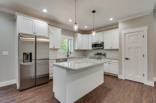 kitchen featuring appliances with stainless steel finishes, a kitchen island, dark hardwood / wood-style floors, and white cabinets