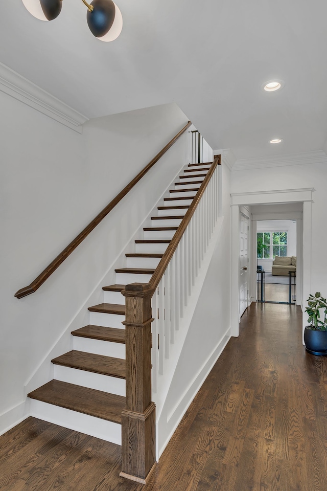 stairway featuring crown molding and hardwood / wood-style floors